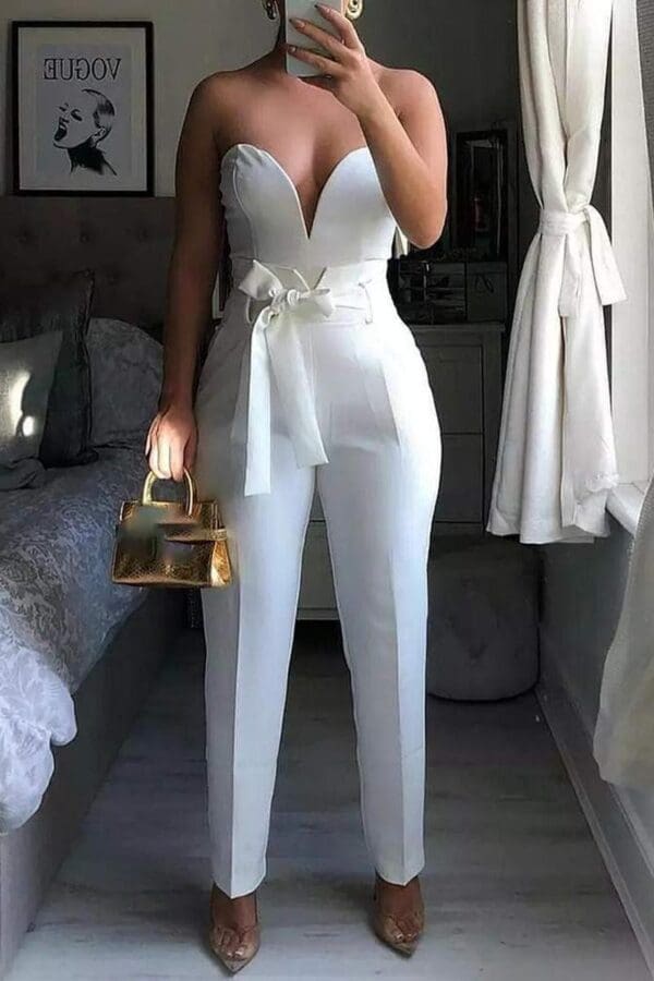 A woman in white pants and a white top