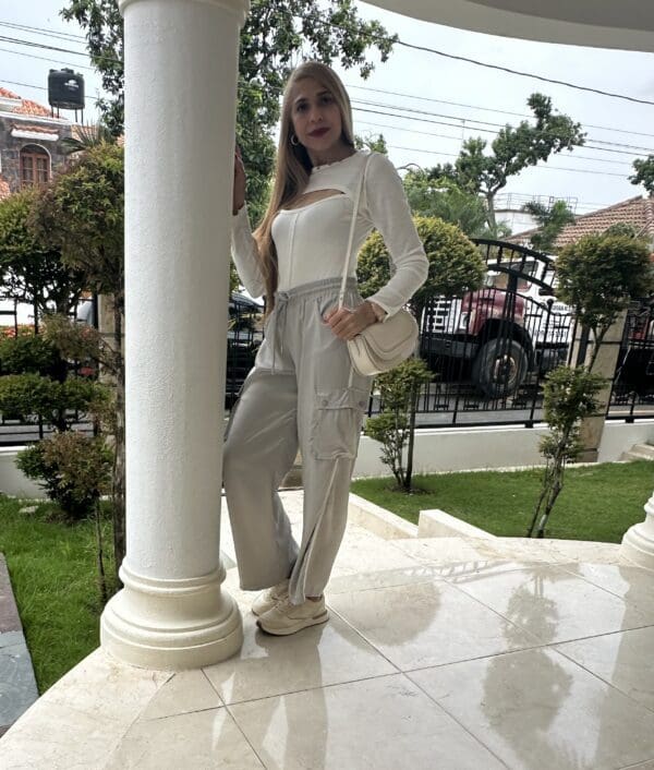 A woman standing on the porch of her home.