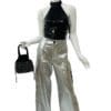 Silver pants, black top, and small bag.