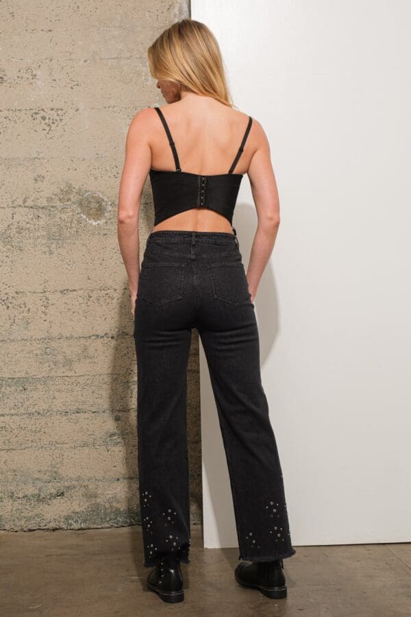 Black corset top and embellished jeans.