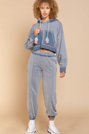 Model in blue cropped hoodie and joggers.