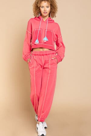Pink hoodie and jogger set with tassels.